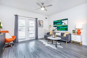 Spacious living room with ceiling fan and patio access